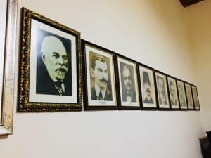 A wall with pictures of the some of the country's leaders