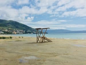 Looking out on the beach in Vlore.  It is a sandy beach.  The only thing you can see on the beach is wooden lookout platform.