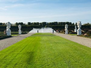 A view of the garden in the Grosser Garten in the Royal Gardens of Herrenhausen in Hannover. You can see a long lawn going down to a fountain