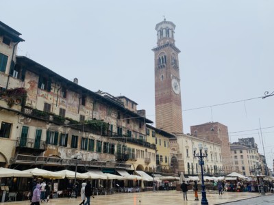 The Torre dei Lamberti - you see this above the shops and restaurants.  It is brown and slim, with a clock on the front.