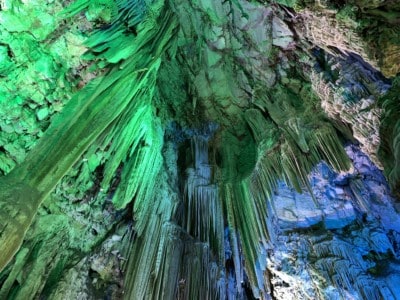 Inside St. Michael's Cave, lit up in green and blue