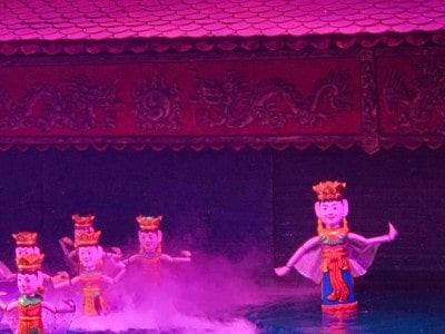 The stage at the water puppet show we saw.  The stage is bathed in pink light here and you can see some of the puppets in the water