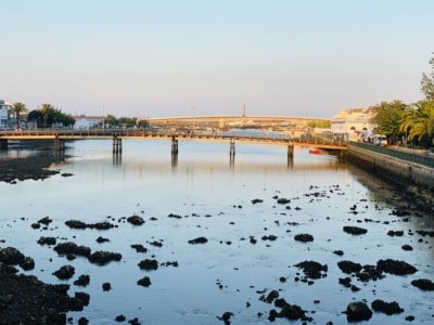 Tavira's river at sunset.  It is low tide so you can see the rocks in the river bed