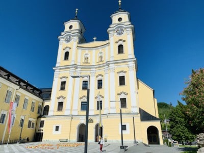 The beautiful pastel yellow coloured cathedral in Mondsee - the was the cathedral where the wedding of Maria and the Captain was filmed in the Sound of Music 