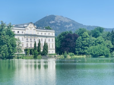 Schloss Leopoldskron sitting by the lake with the mountains in the background - this provided exterior scenes in the Sound of Music