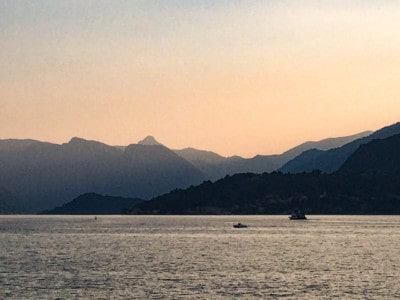 Sunset on Lake Como. You can see the sun setting across the lake and over the mountains in the background