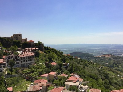 A view of part of Kruja with houses on the hills and a view over the valley