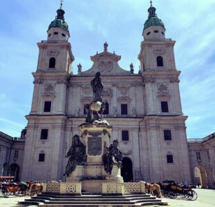 Salzburg's cathedral with a large statue in the front.